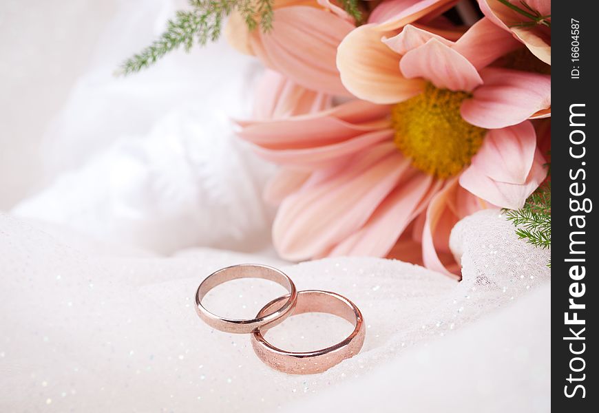 Closeup of wedding rings and flowers