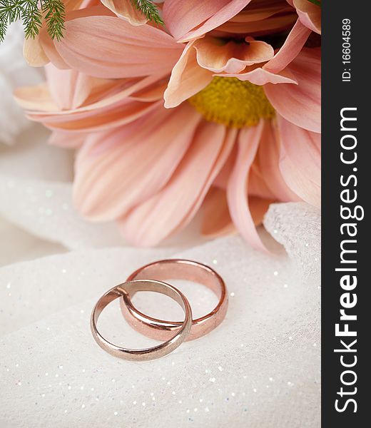Closeup of wedding rings and flowers