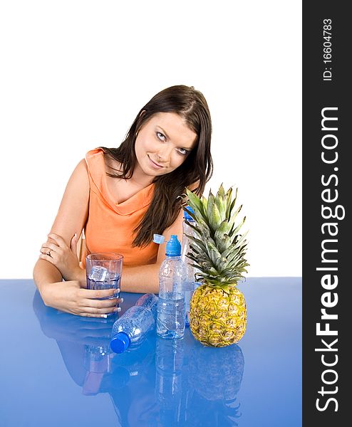 Beautiful young girl sitting in a blue desk. Accompanied by fruit girl