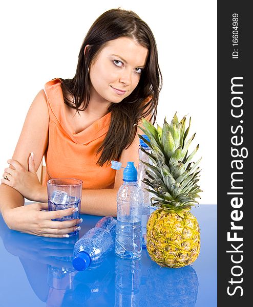 Beautiful young girl sitting in a blue desk. Accompanied by fruit and water girl. Beautiful young girl sitting in a blue desk. Accompanied by fruit and water girl.