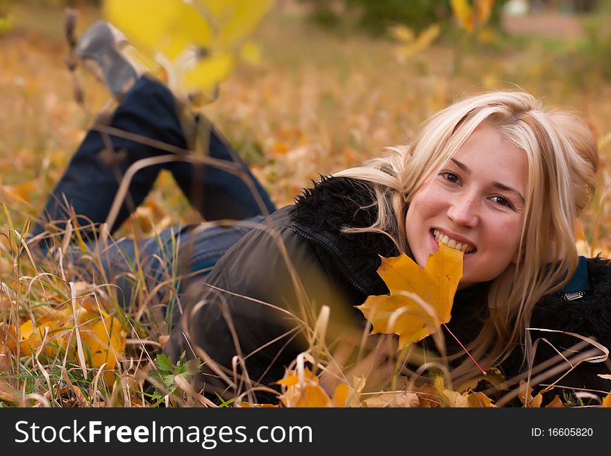 Beautiful Young Woman In Autumn Leaves