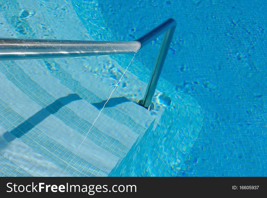 Steps and handrail of a swimming pool