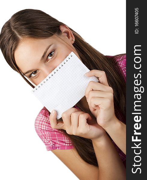 A young girl covers her face with a notebook on a white background. A young girl covers her face with a notebook on a white background.