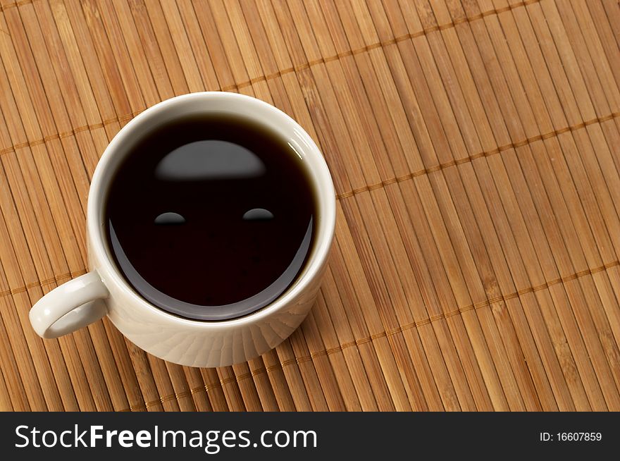 Little white espresso coffee cup on a bamboo mat (upprer view). Little white espresso coffee cup on a bamboo mat (upprer view)