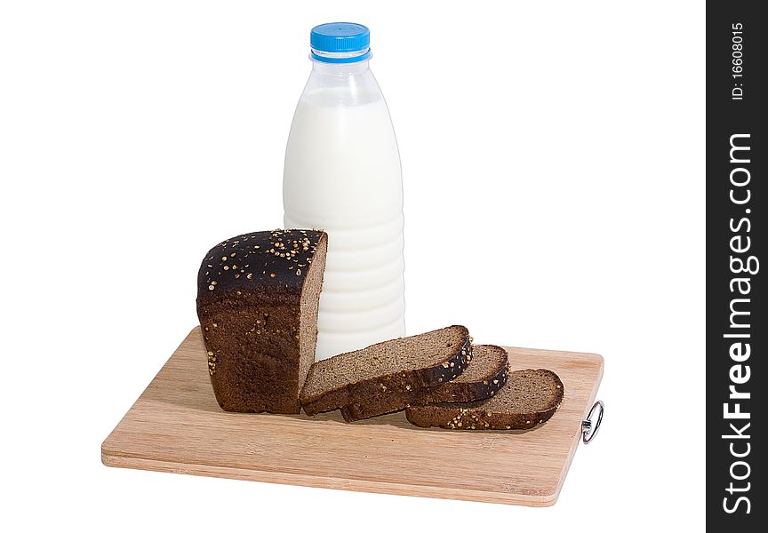 Bottle of milk and rye bread on a board