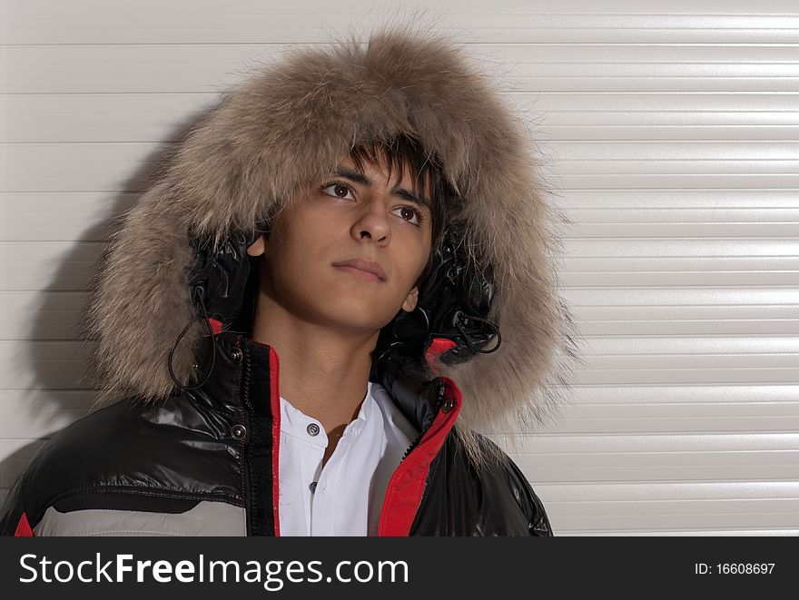 Portrait of a handsome young man of sixteen. Youth shows autumn, winter clothing. Portrait of a handsome young man of sixteen. Youth shows autumn, winter clothing.