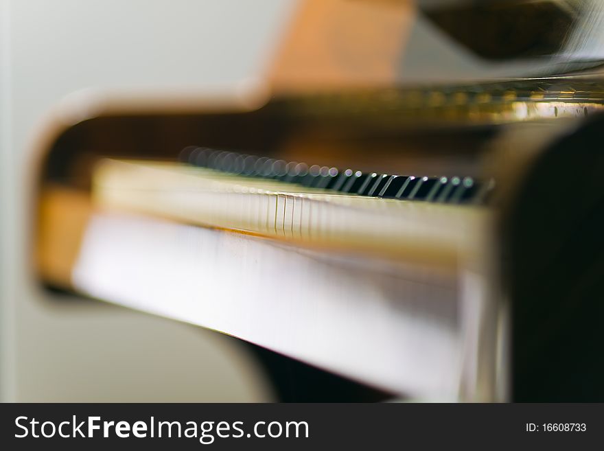 Wooden upright piano fragment shot with little dof. Wooden upright piano fragment shot with little dof