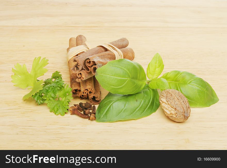 Fresh herbs and spices on a wooden board