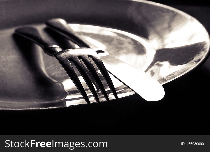 Plate with a Knife and fork on top
