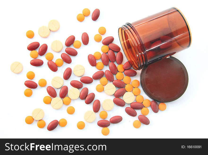 Isolated top Perspective of Open pill bottle with medicine spilling out