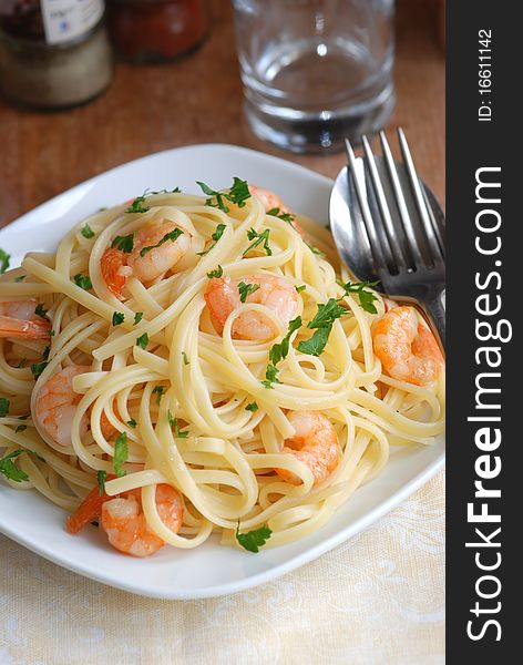 Linguine with garlic and king prawns on a plate. Linguine with garlic and king prawns on a plate