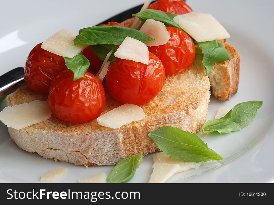 Toast with cooked tomatoes parmesan and basil