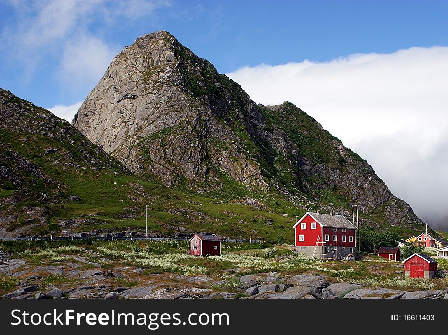 Red houses near rocky mountain