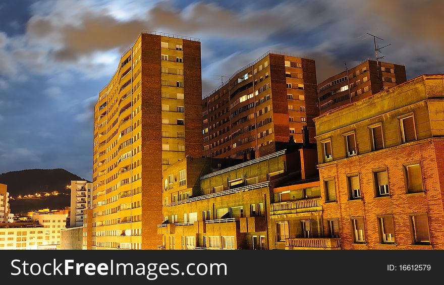 Illuminated office building under a clouded night sky in the Spanish City of Bilbao. Illuminated office building under a clouded night sky in the Spanish City of Bilbao