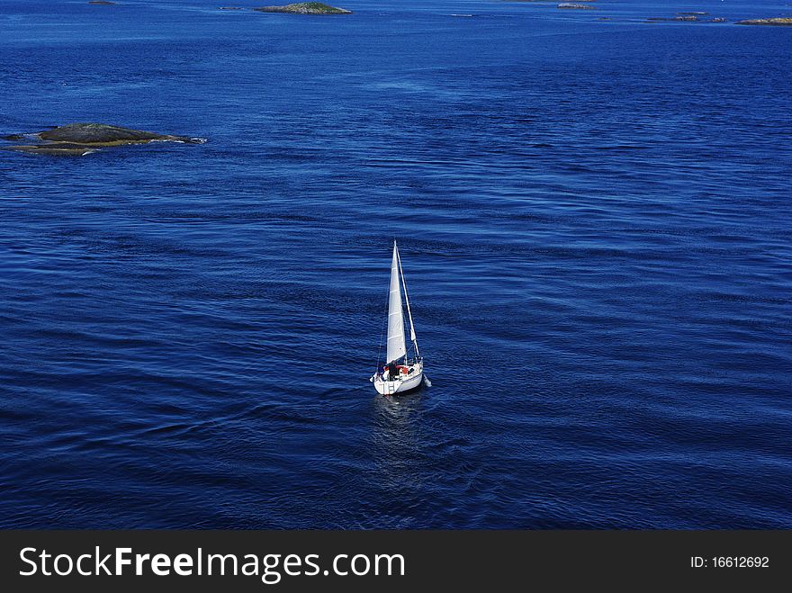 Single sailboat floating on the calm sea. Single sailboat floating on the calm sea