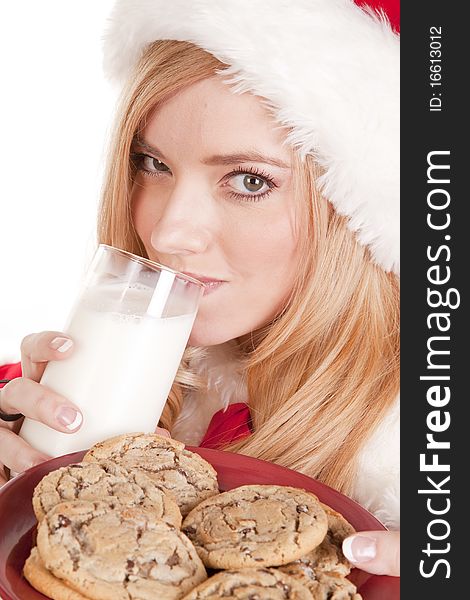 A close up shot of Mrs Santa drinking milk and holding cookies. A close up shot of Mrs Santa drinking milk and holding cookies.