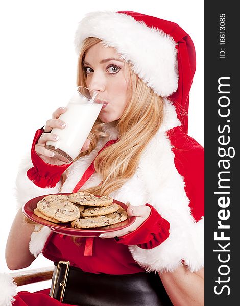 Mrs Santa has a plate of cookies and is drinking some milk. Mrs Santa has a plate of cookies and is drinking some milk.