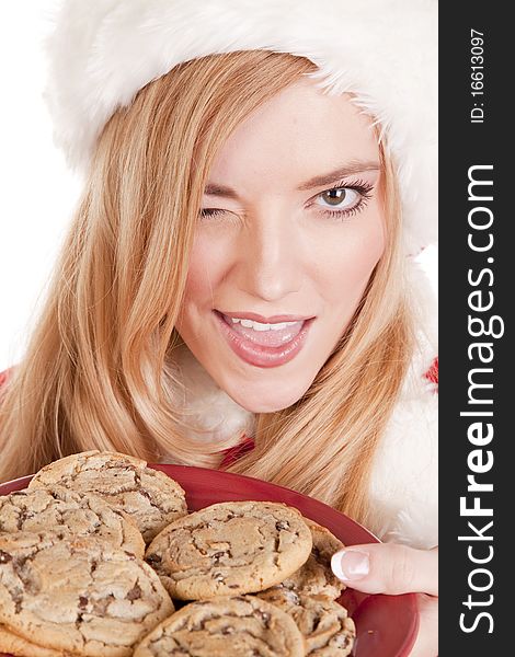 Mrs Santa has a plate of cookies and is winking. Mrs Santa has a plate of cookies and is winking.