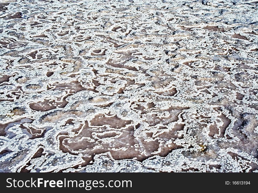 Beautiful stone structure at the coast line with dried salt painting an artificial picture