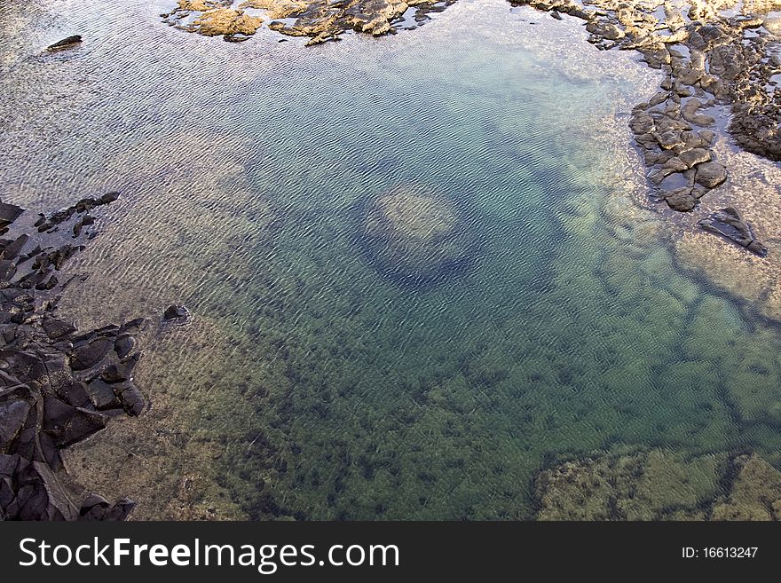 Beautiful stone structure at the coast line giving a natural pool with saltwater