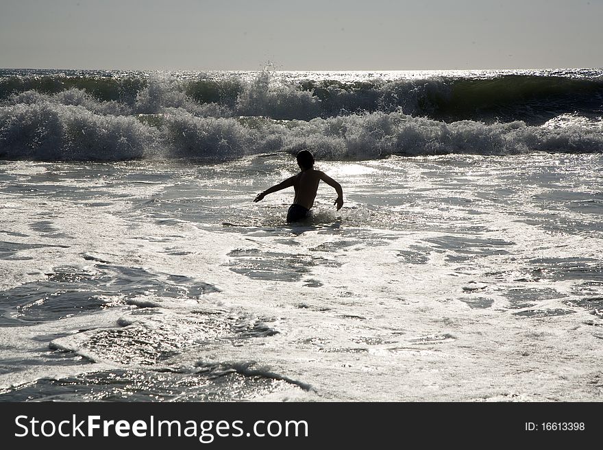 Swimmer in silver light at sunset