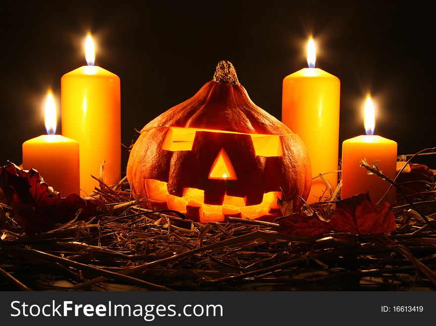 Halloween pumpkin and lighted candles. Halloween pumpkin and lighted candles