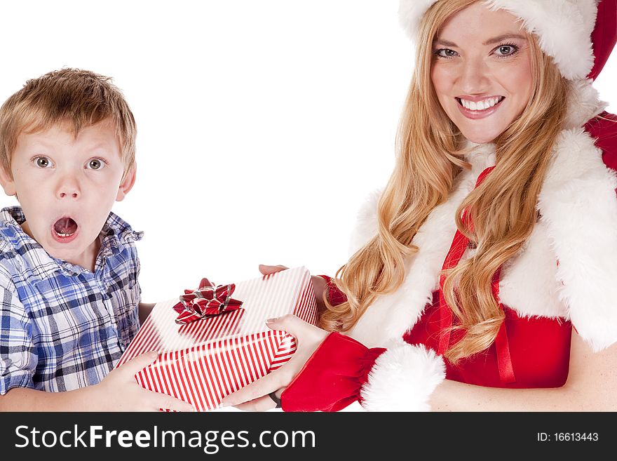 Mrs Santa is giving a surprised young boy a gift. Mrs Santa is giving a surprised young boy a gift.