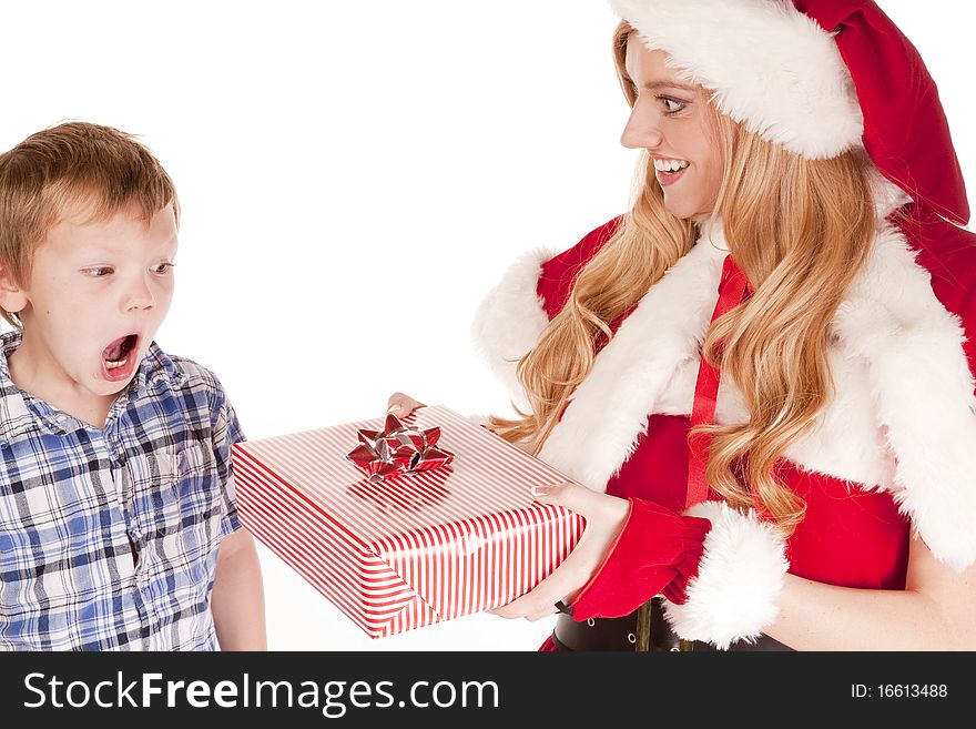 Mrs Santa is giving a surprised young boy a gift. Mrs Santa is giving a surprised young boy a gift.