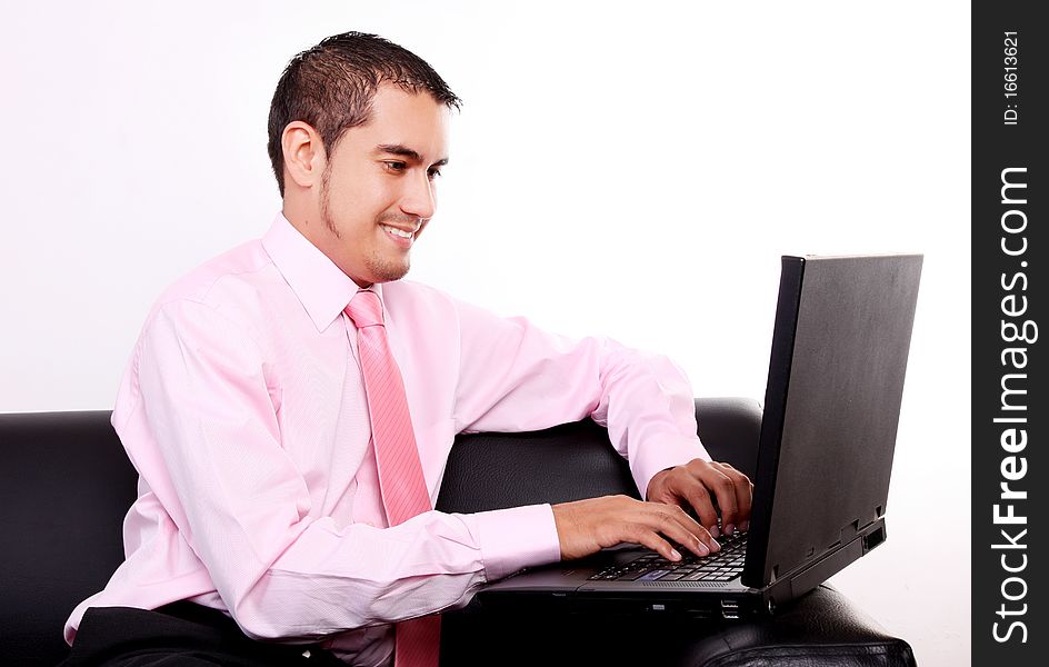 Young businessman typing on laptop. White background