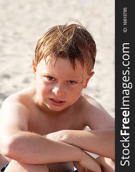 Child, boy at the beach is angry and his face looks annoyed. Child, boy at the beach is angry and his face looks annoyed