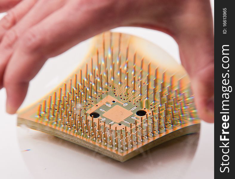 CPU under the magnifying glass in the human hand