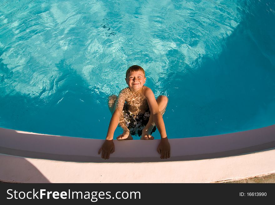 Child is posing in the pool