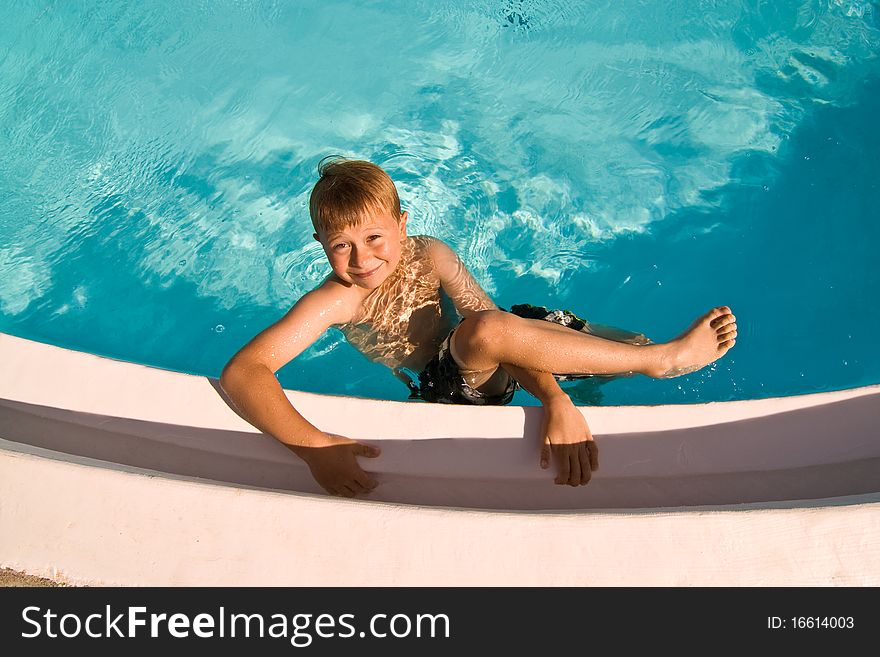 Child is posing in the pool and makes fun