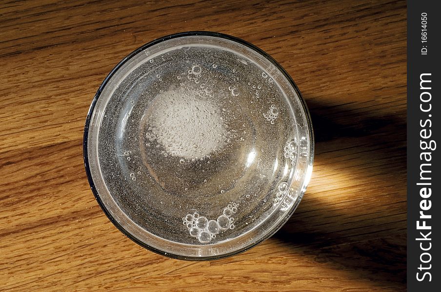 Medicine in a glass of sparkling water