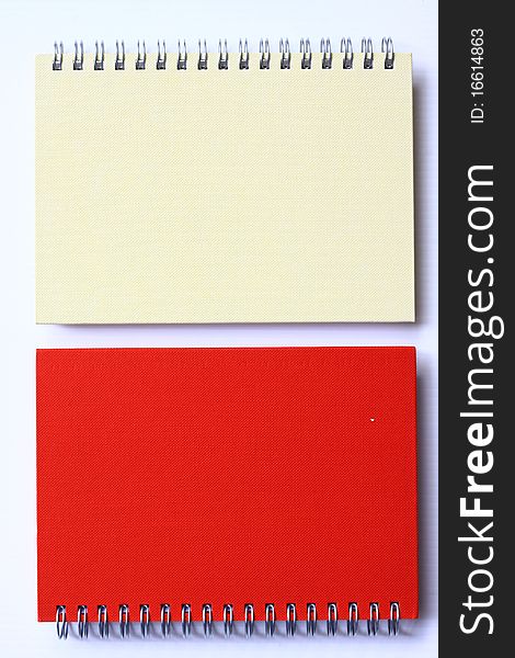Red and white note book on white background