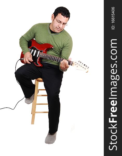 A middle aged man sitting in the studio, playing his guitar in dress pants
and green sweater, for white background. A middle aged man sitting in the studio, playing his guitar in dress pants
and green sweater, for white background.