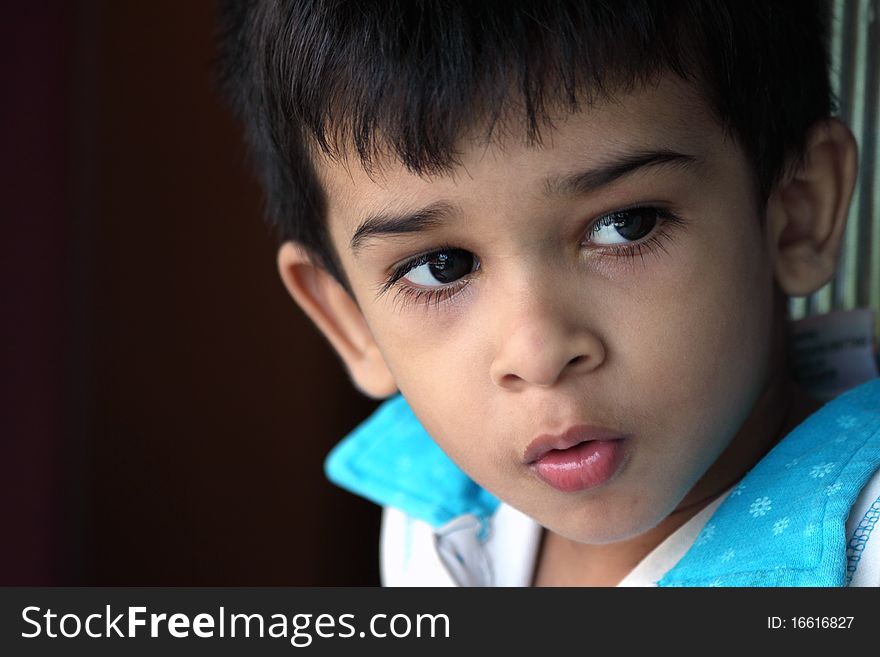 Indain Cute Boy Looking Somewhere With Some Expression