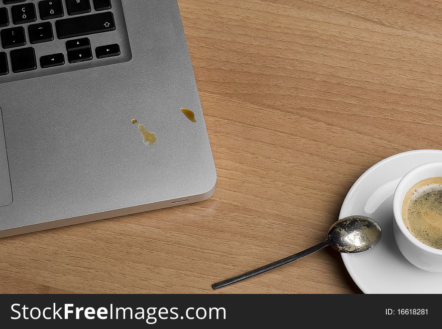 Coffee cup and laptop on the table