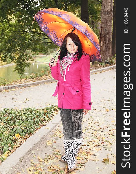 Girl in the autumnal park with the umbrella. Girl in the autumnal park with the umbrella