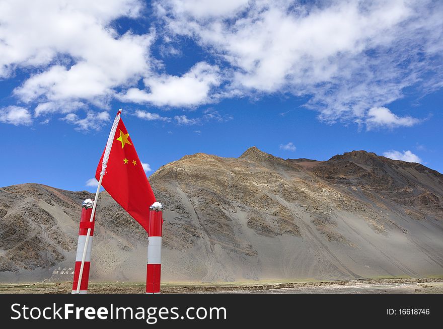National flag of China is flowing between heaven and a high mountain. National flag of China is flowing between heaven and a high mountain.