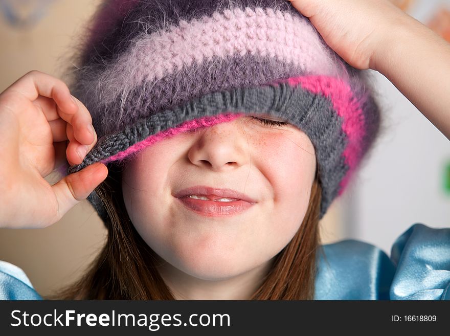 Portrait of funny smiling girl in a hat indoors. Portrait of funny smiling girl in a hat indoors