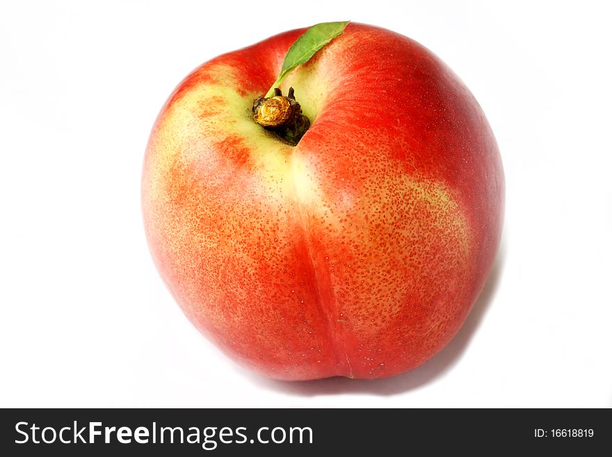 Ripe peach fruit with green leafs isolated on white background