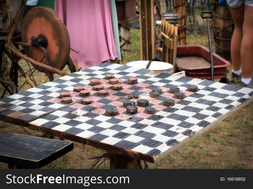 A large checkered checkerboard table at a rural arts and crafts fair in Michigan. A large checkered checkerboard table at a rural arts and crafts fair in Michigan.