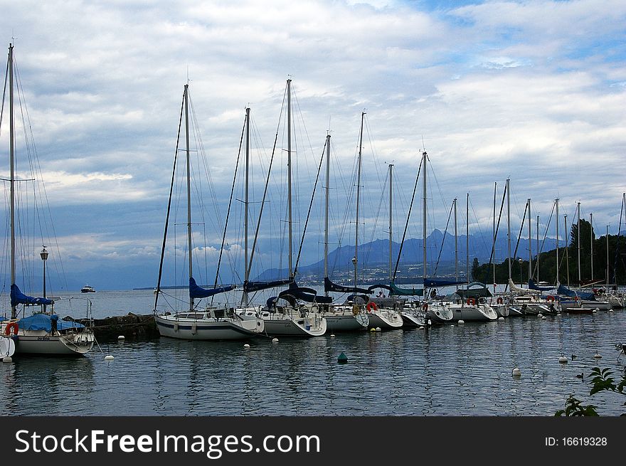 Yachts moored in Yvoire  port in France  on the Leman lake. Yachts moored in Yvoire  port in France  on the Leman lake