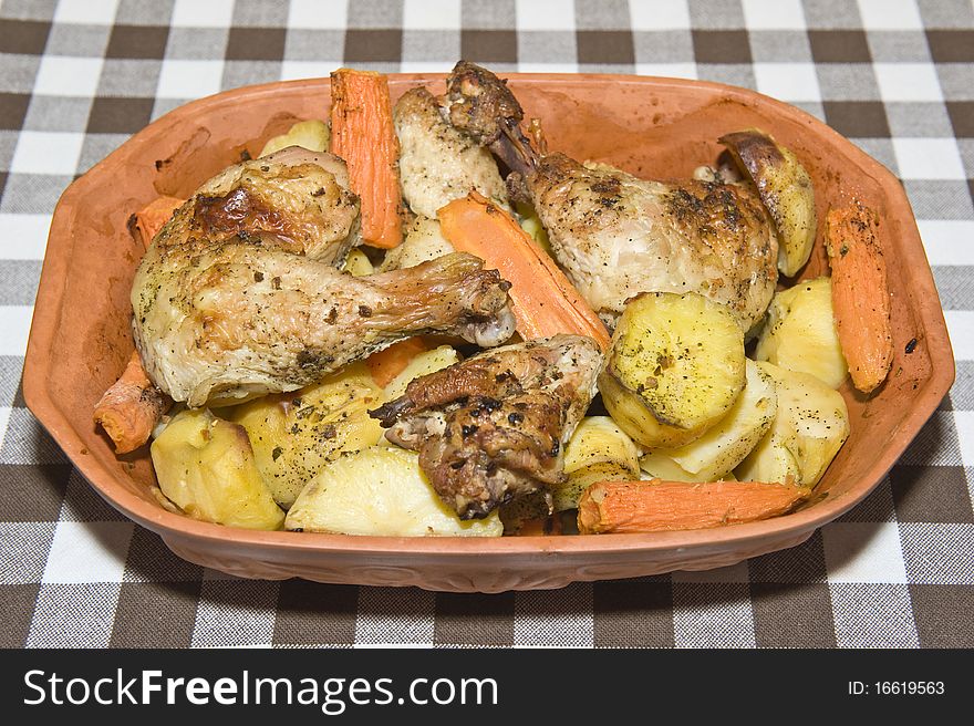 Roasted chicken and potatoes on a pot