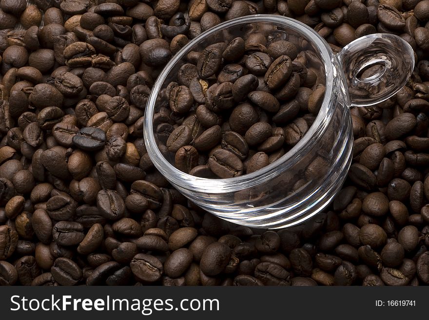 Topview of a glass coffee cup filled with coffee beans