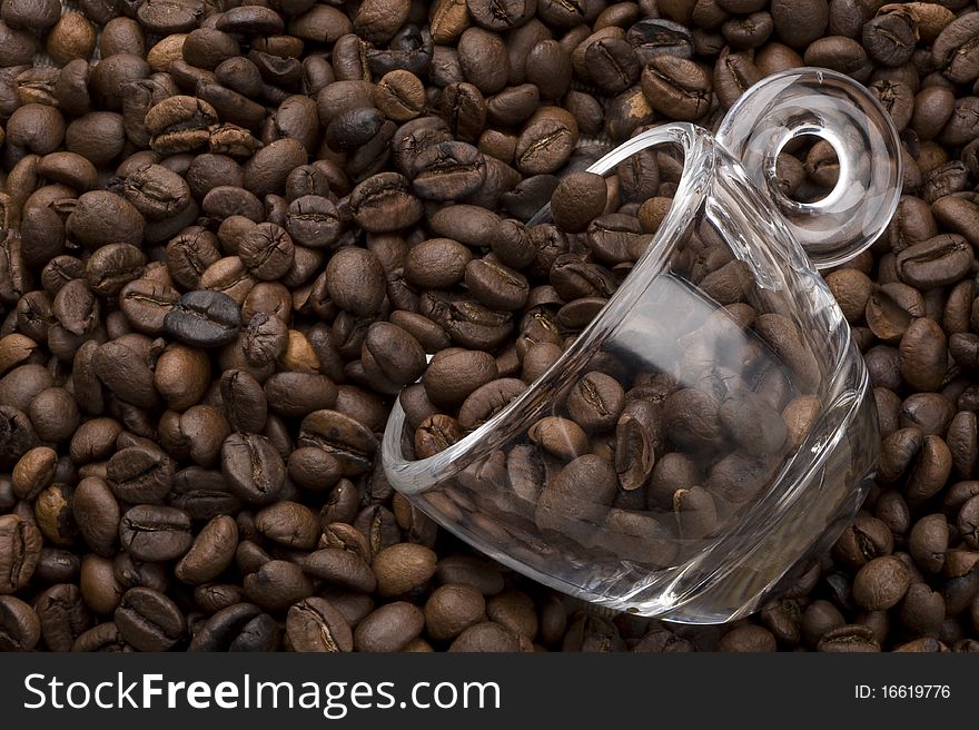 Topview of a glass coffee cup filled with coffee beans