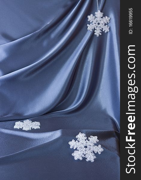 Satin background with Christmas decorations; place for your object. Satin background with Christmas decorations; place for your object