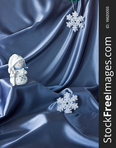 Satin background with Christmas decorations; place for your object. Satin background with Christmas decorations; place for your object