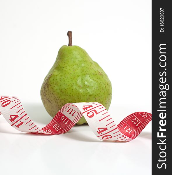 A pear and a measuring tape. A pear and a measuring tape